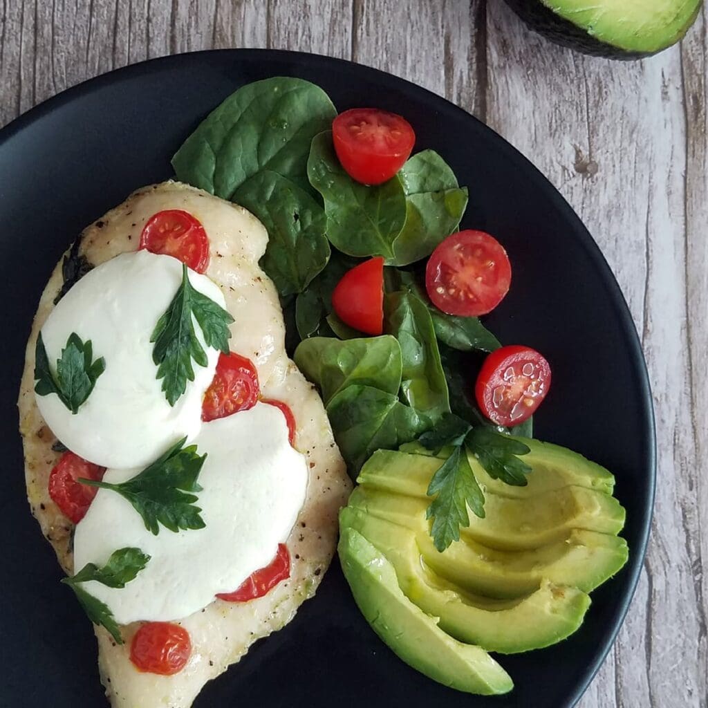 Chicken Pizza with a side salad and avocado