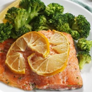 Salmon and broccoli with lemon on a plate