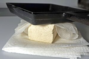 Tofu with a heavy pan on top
