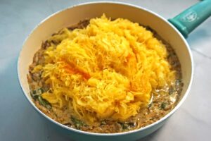 Mixing spaghetti squash with sauce