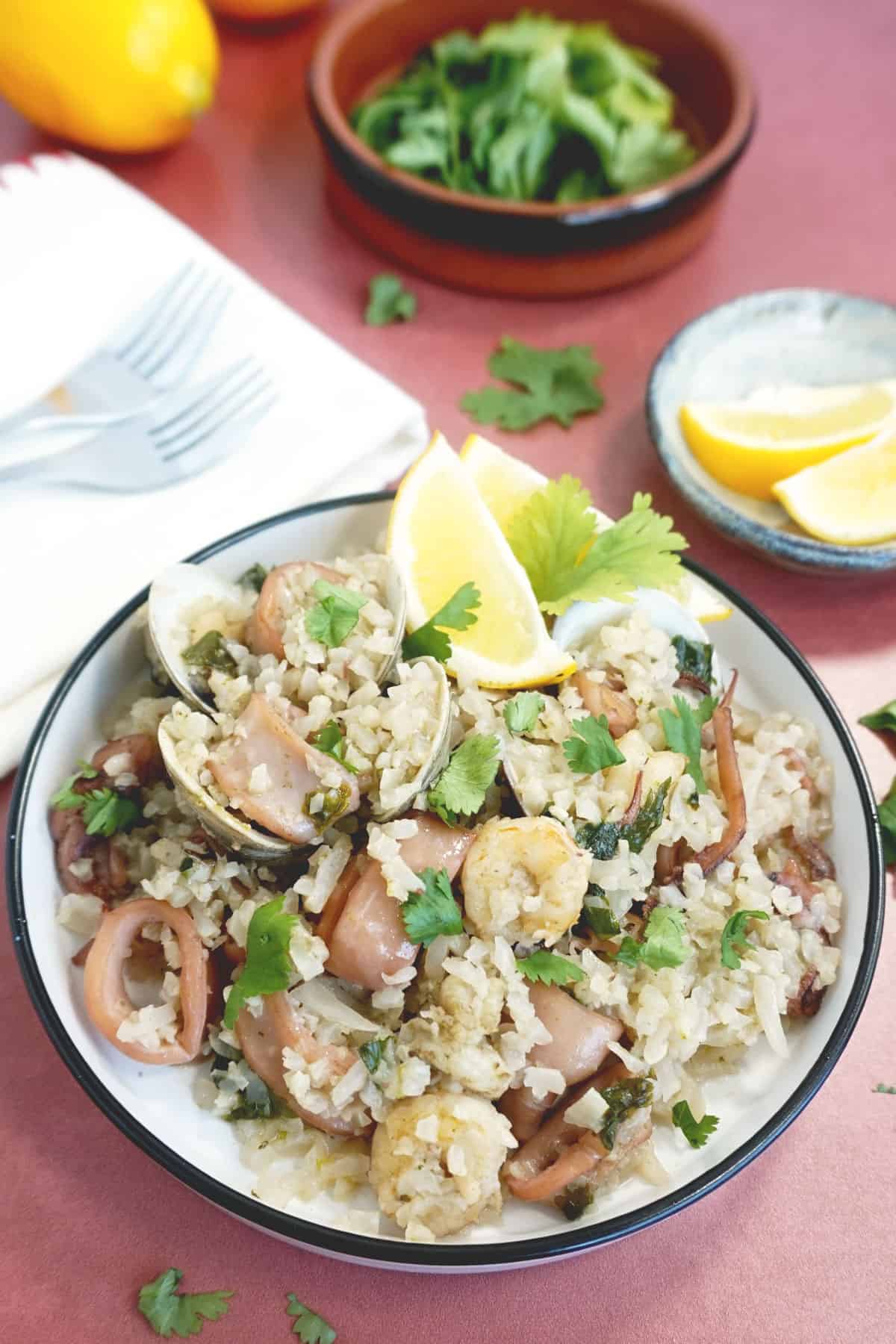 Bowl of seafood and rice with cilantro on top